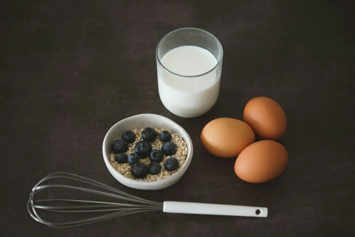 A breakfast arrangement of oats, blueberries, eggs and milk